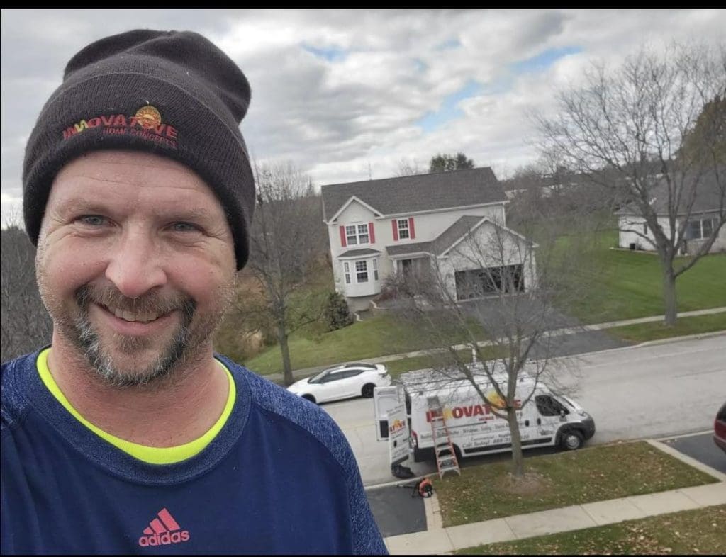Nate on a roof doing a repair