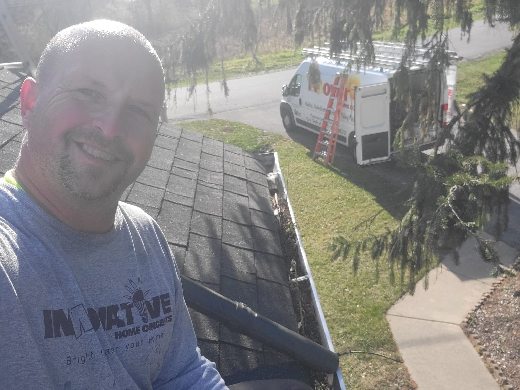 IHC technician cleaning gutters before gutter guard installation in McHenry County
