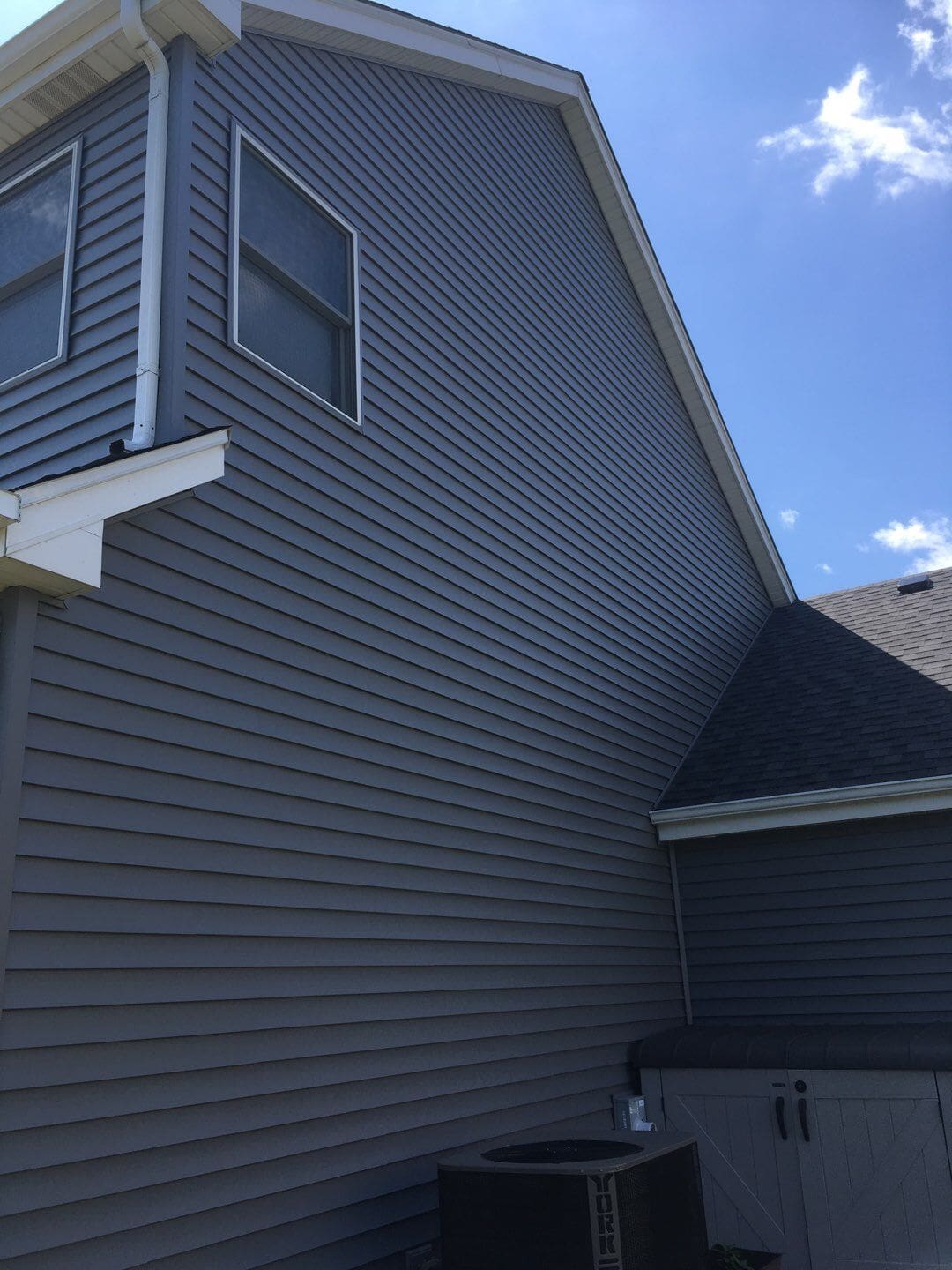 Vinyl siding installation side view showing proper overlap and alignment on McHenry County home