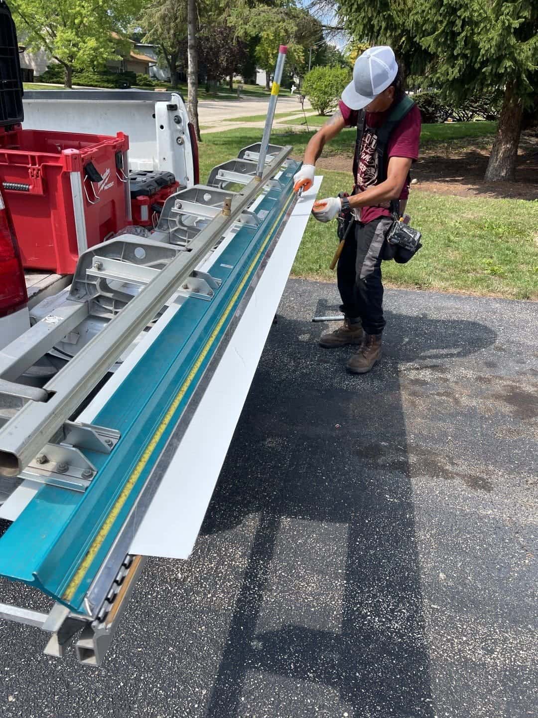Worker using a metal brake to fabricate custom trim