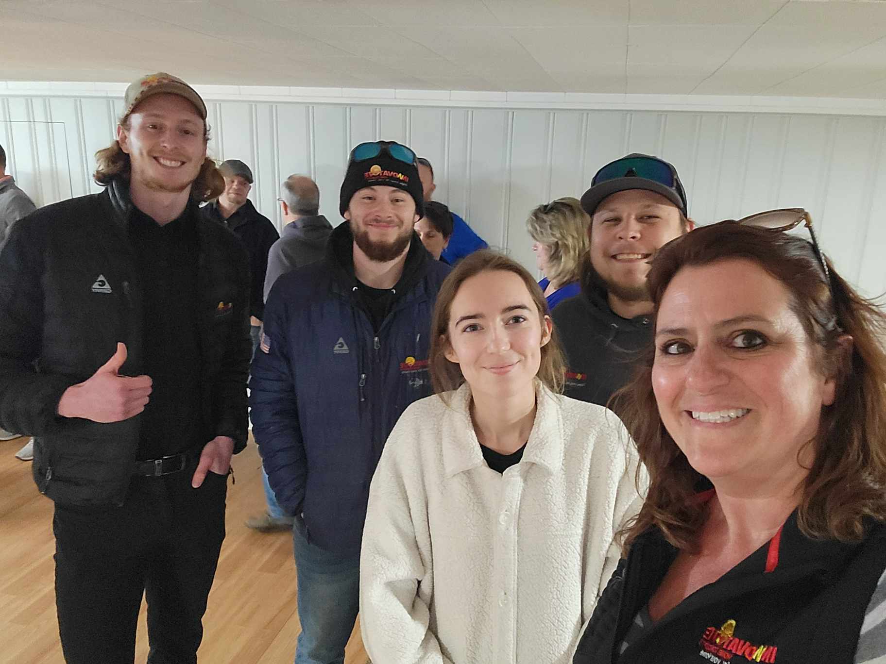 Team standing in front of company van