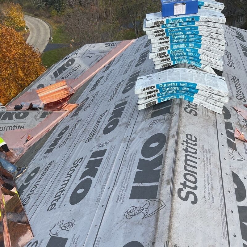 IKO asphalt roofing system IKO roofing system being installed on home in Woodstock. Notice the copper accessories.