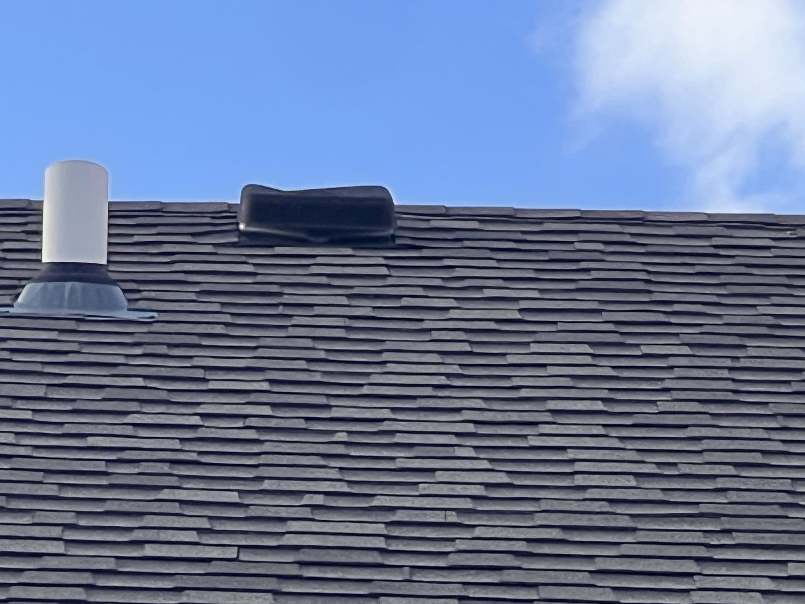 Steep-slope commercial roof with synthetic slate shingles installed by IHC