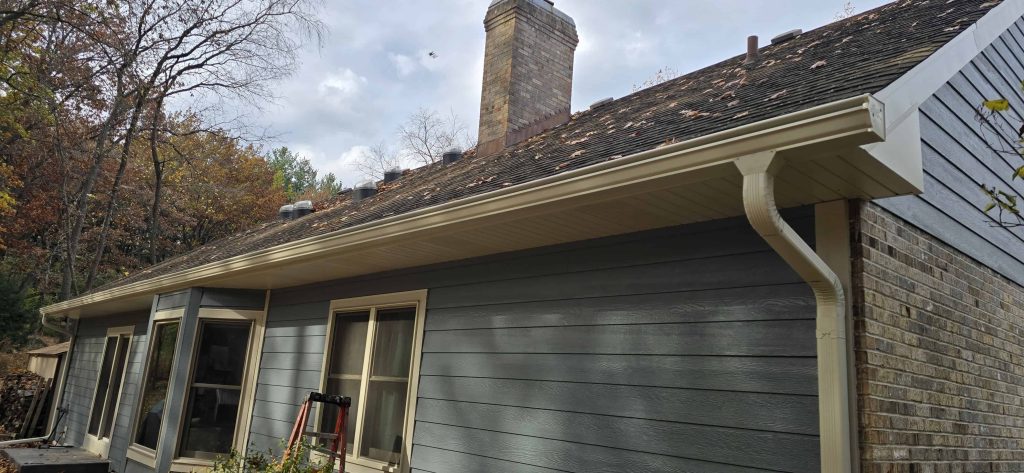 Roof repair and gutter installation on a residential home.