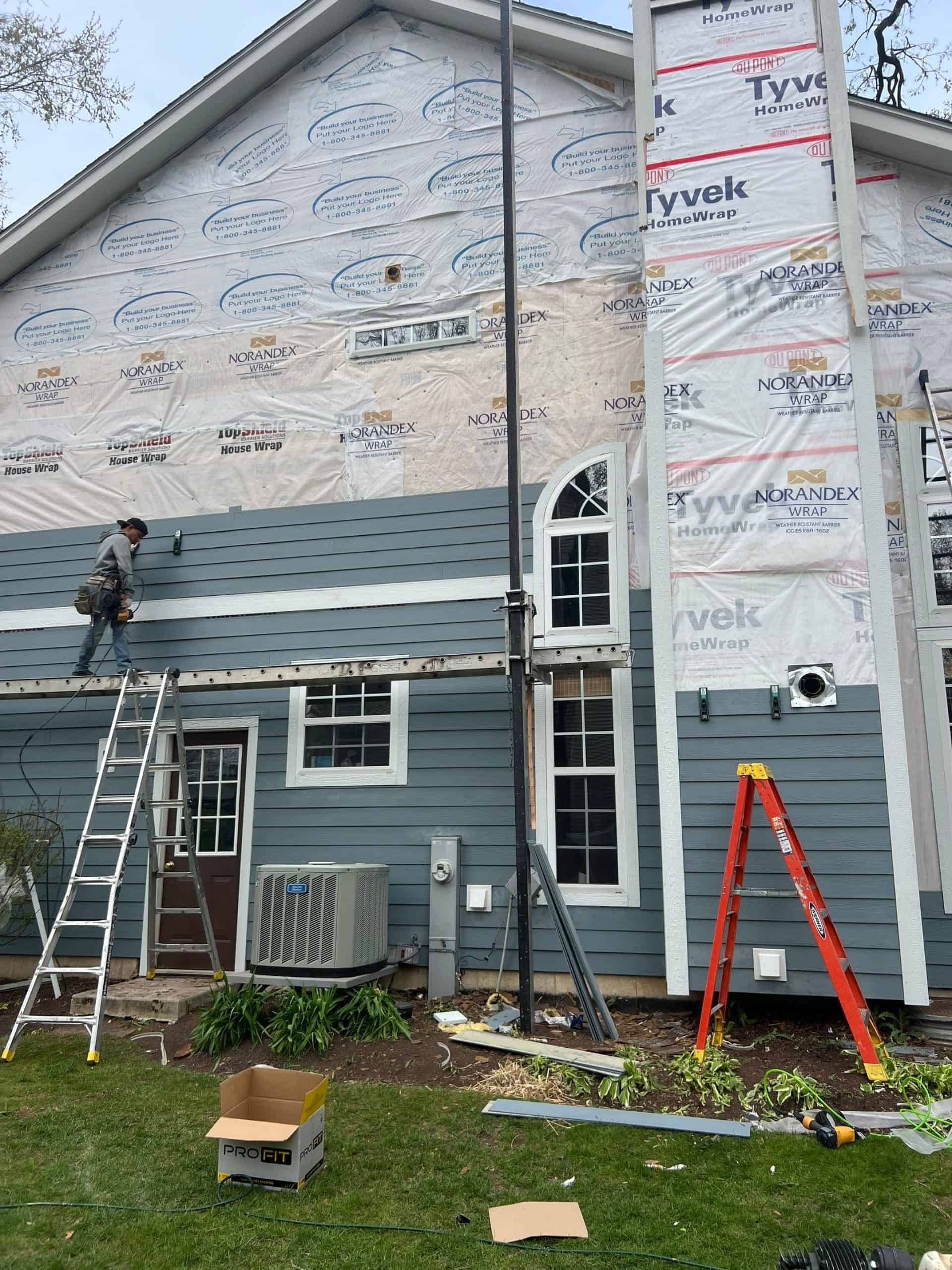 HardiePlank being installed over house wrap