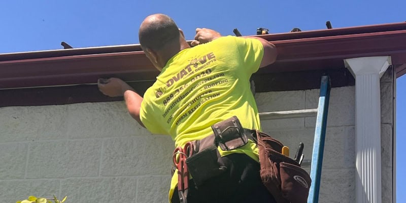 Nate from Innovative Home Concepts installing GutterShutter on a McHenry County home