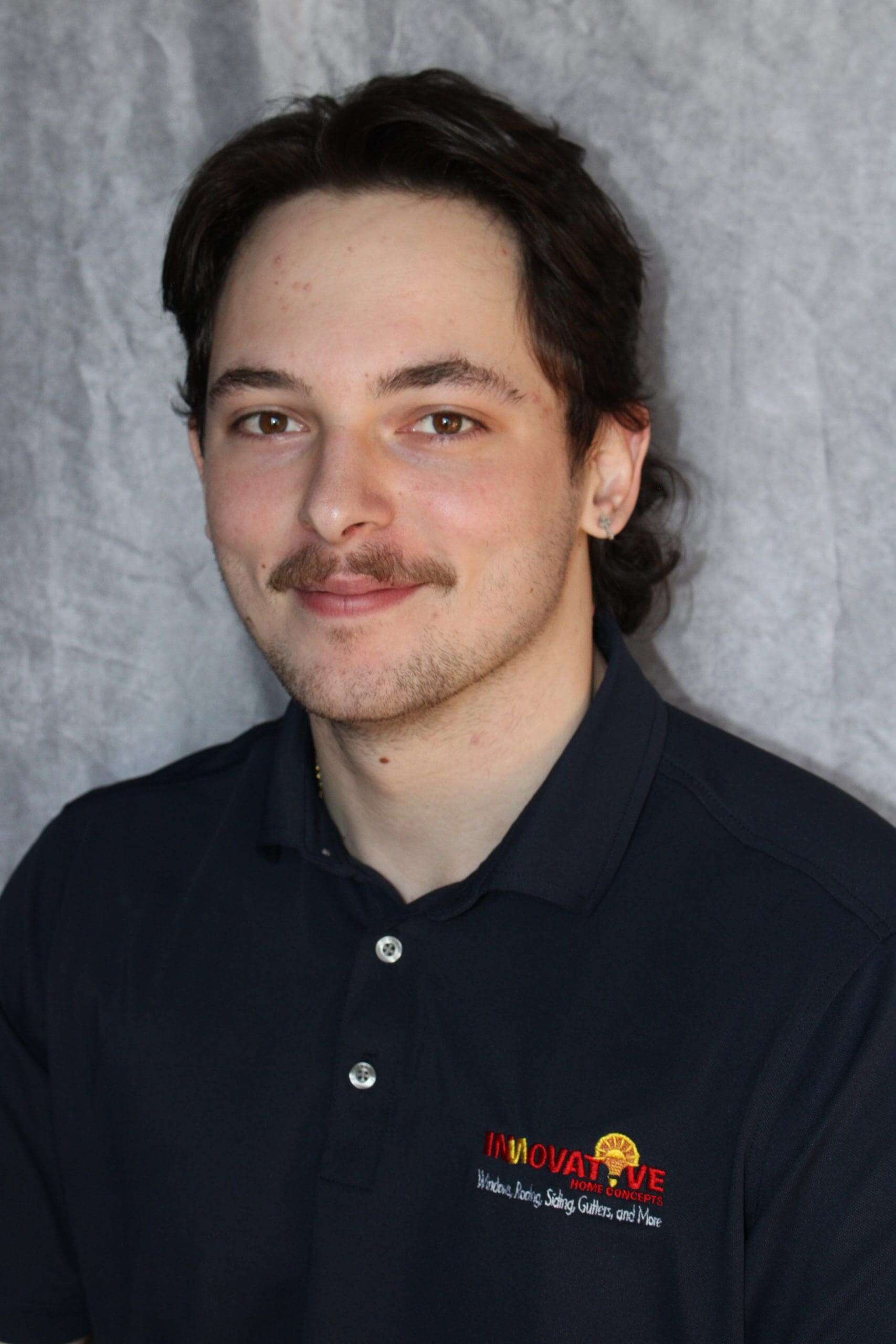Professional portrait of a man in a black polo shirt with Innovative Home Concepts logo.