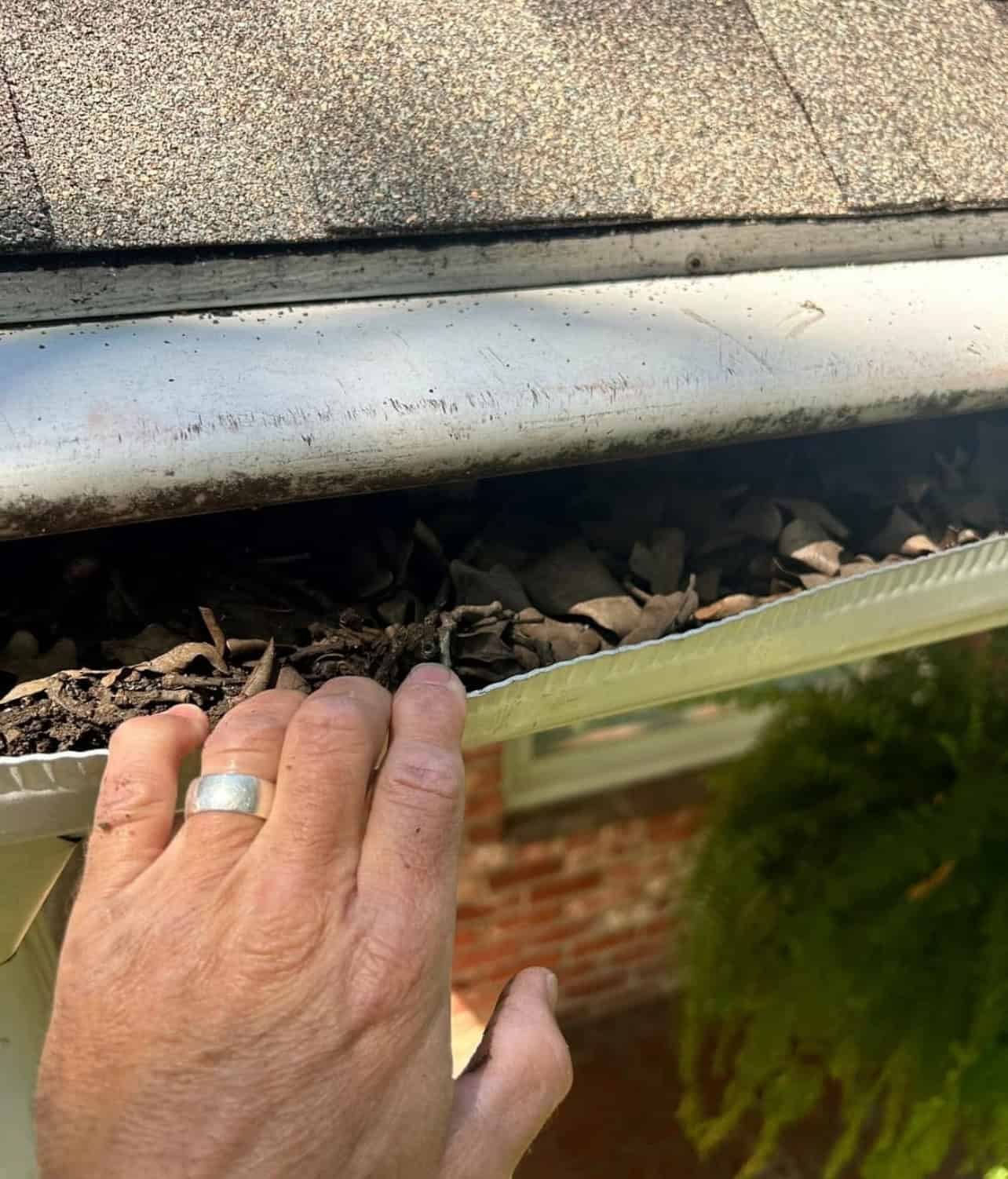 LeafGuard gutter being pulled open to show interior design