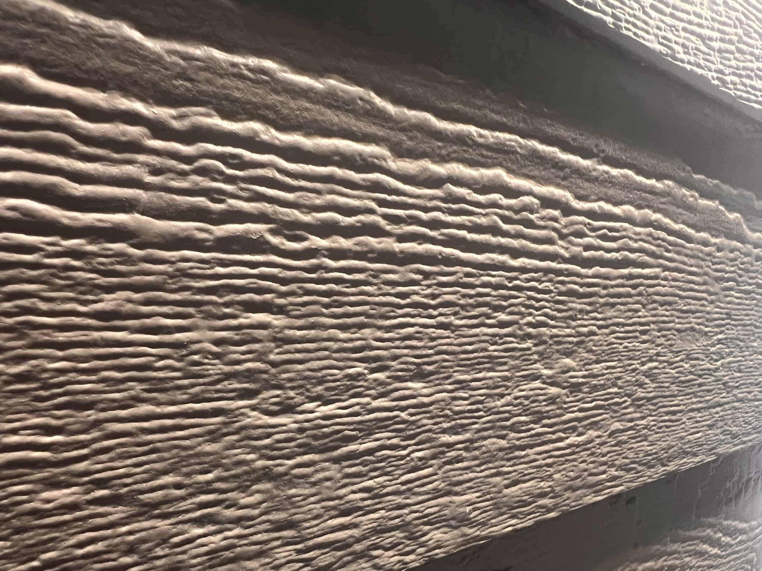 Close-up of textured wood siding for home exterior renovation.