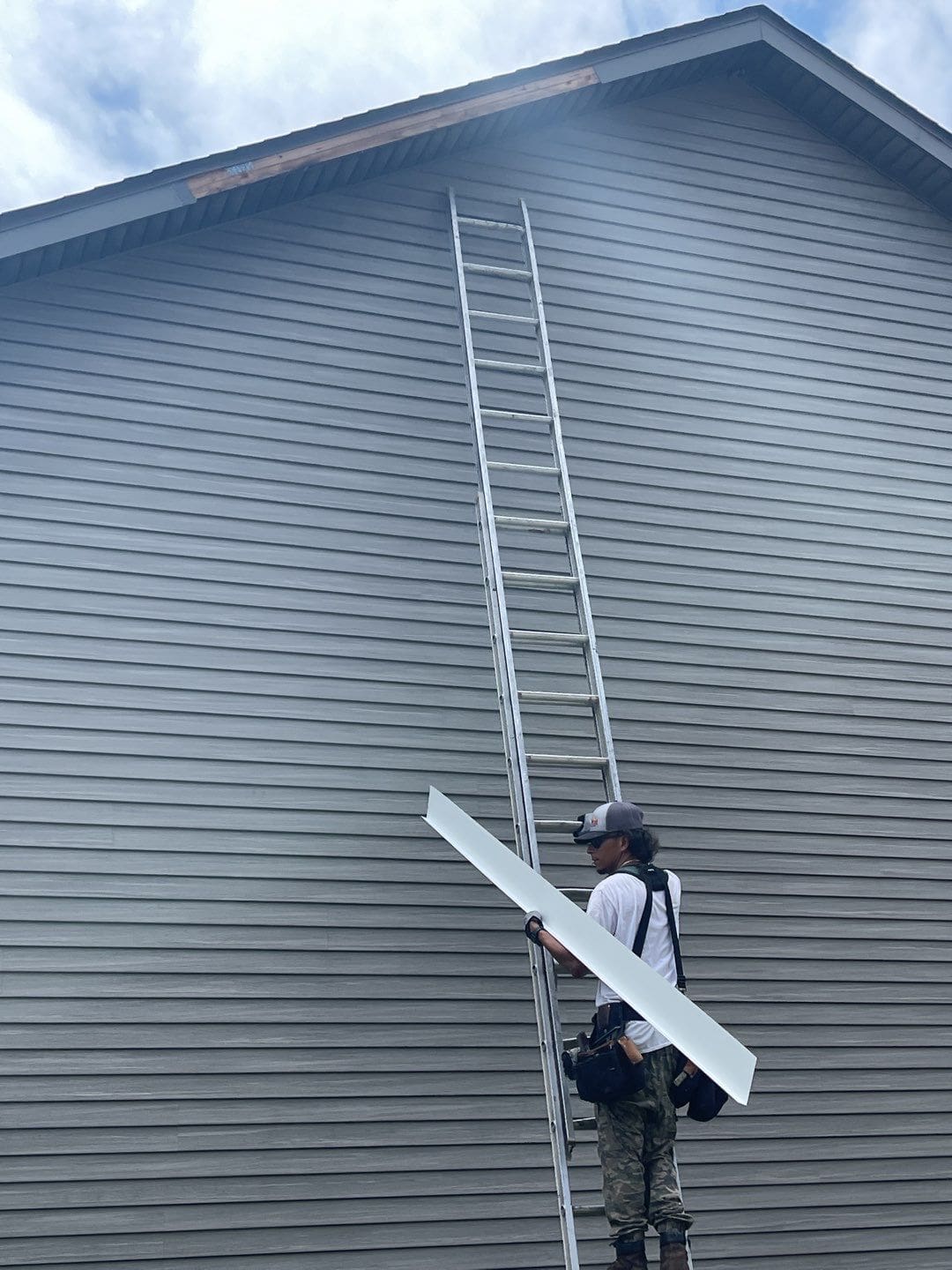 Repairing aluminum wrap on a gable end of a home