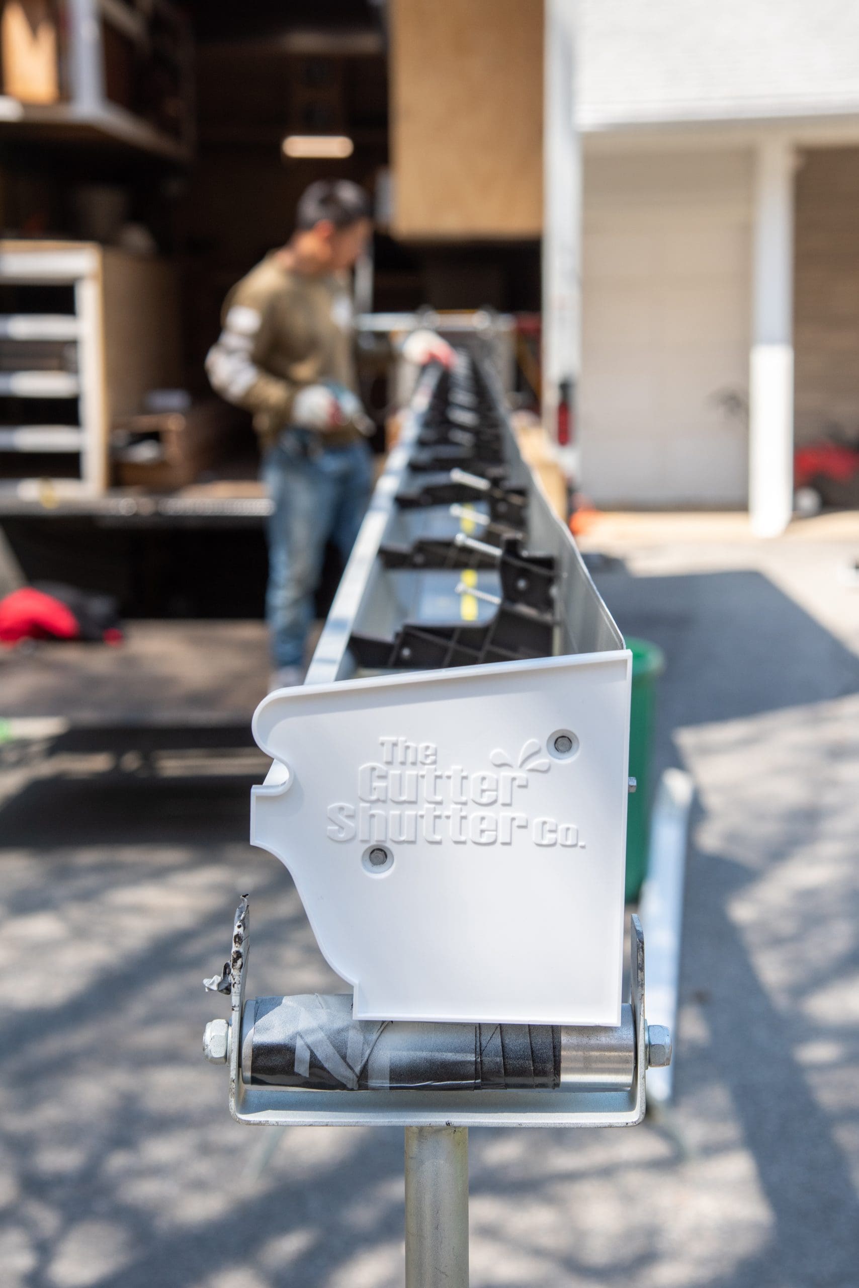 GutterShutter gutter guard system showing water runoff on a building in McHenry County IL