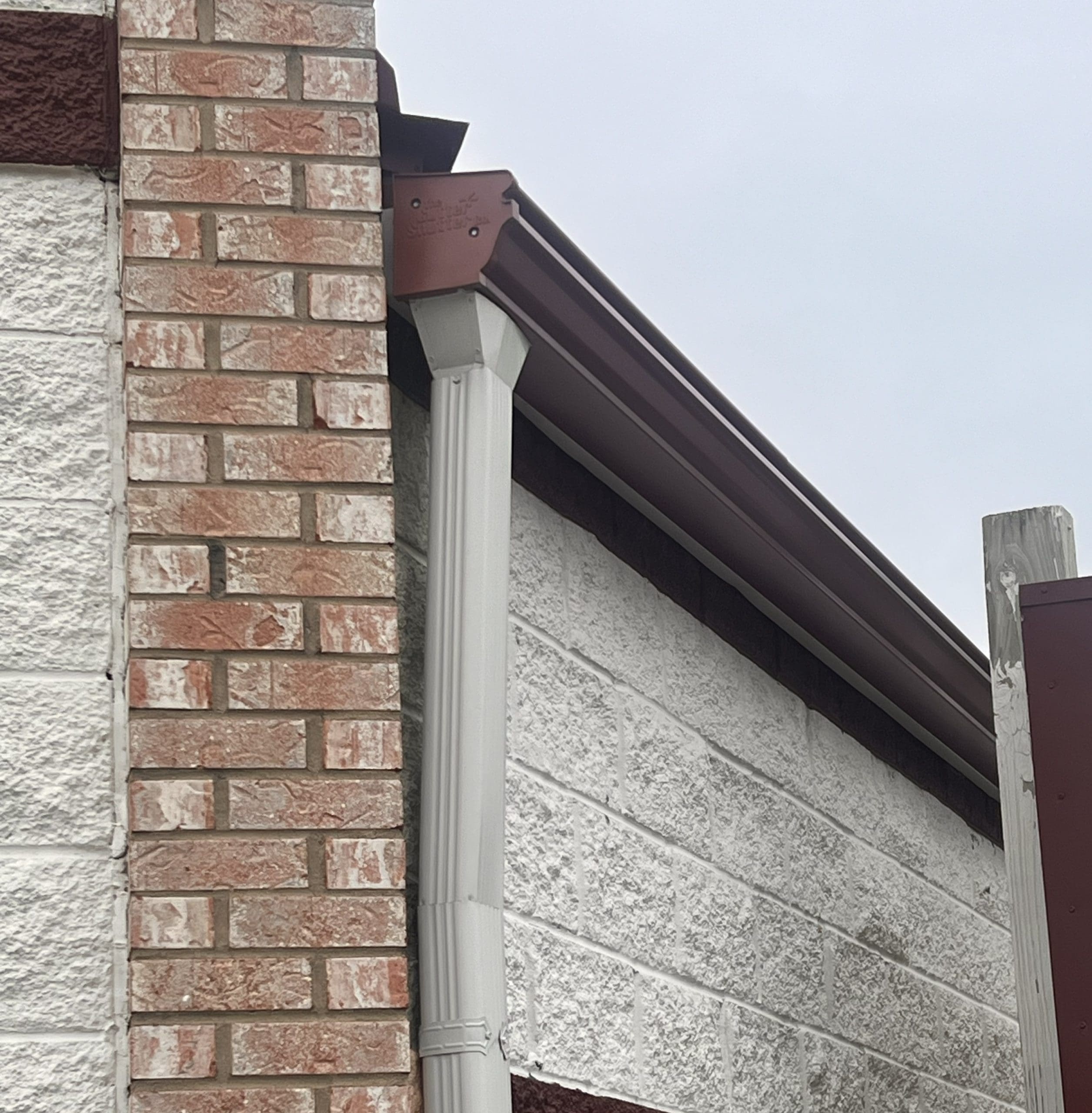 Close-up of GutterShutter one-piece aluminum gutter and hood system on a building in Crystal Lake IL