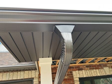 Close-up of GutterShutter gutter system with oversized downspout installed on a home in McHenry County IL