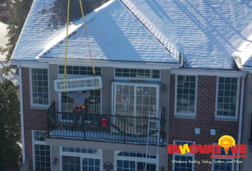 IHC crew installing custom Andersen windows with a crane on a McHenry County home