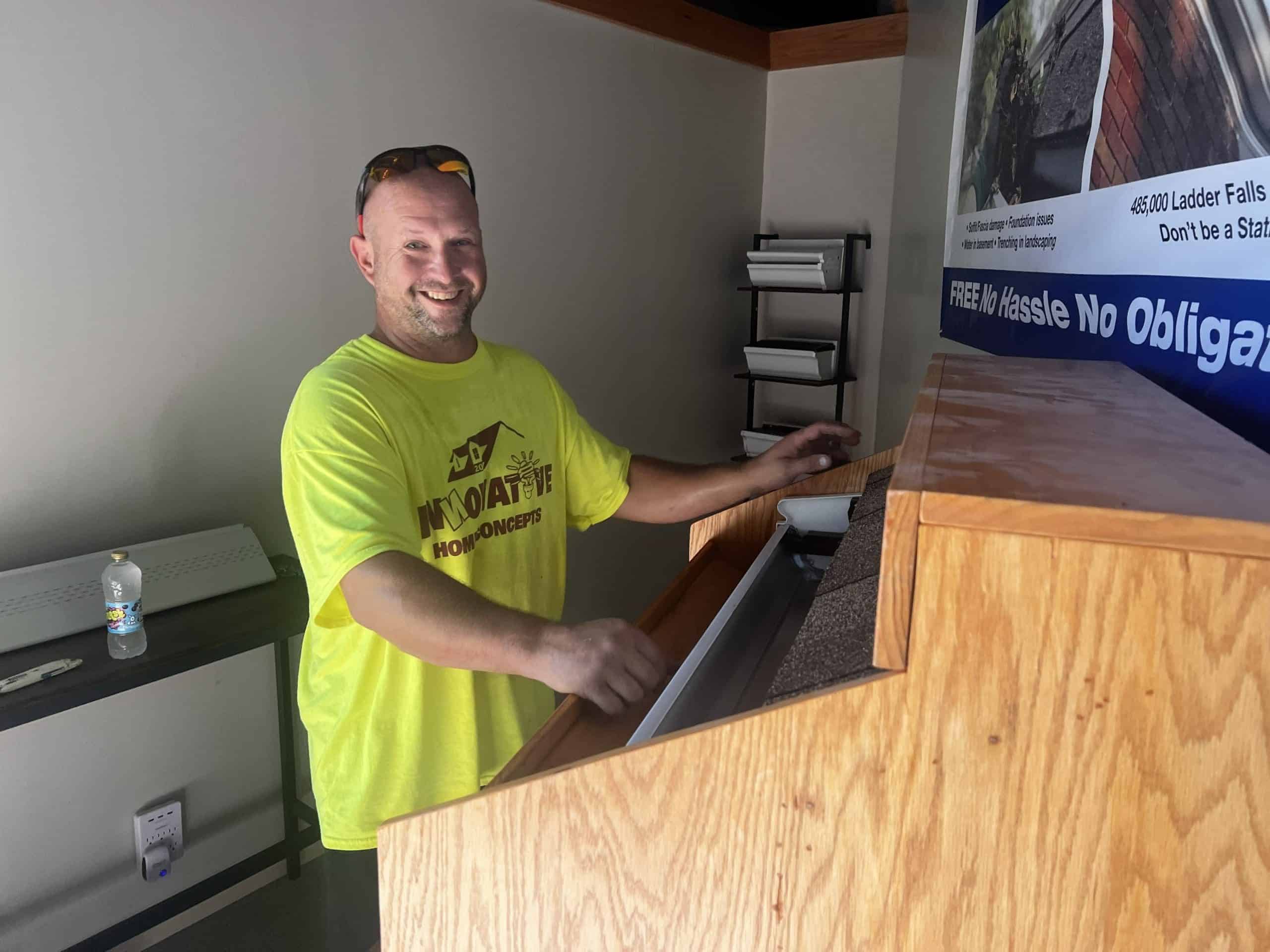 Nathan Druml in the IHC showroom explaining gutter options to a customer