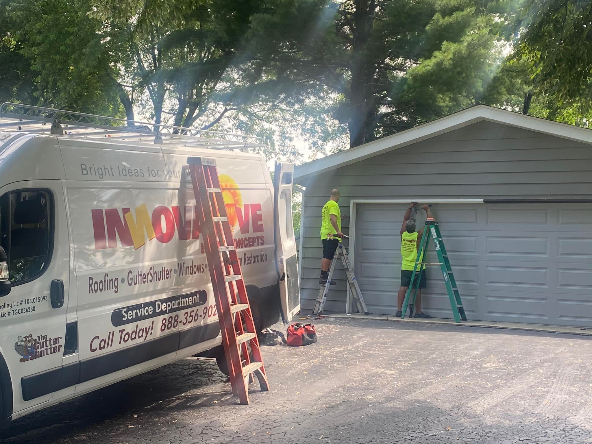 IHC technician repairing exterior trim on a garage door opening