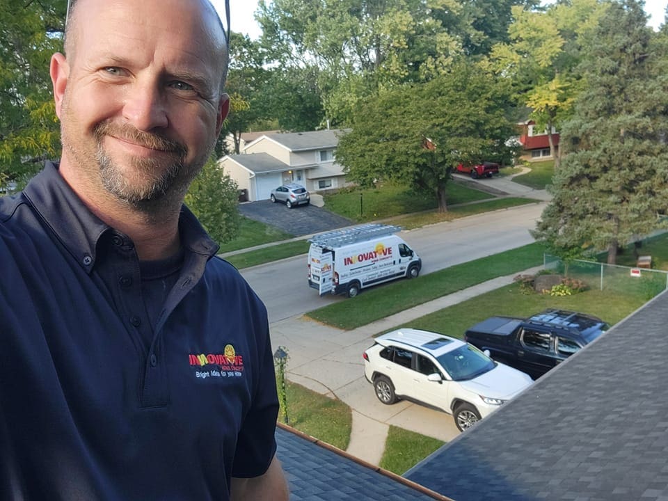 IHC representative inspecting storm damage on a McHenry County roof