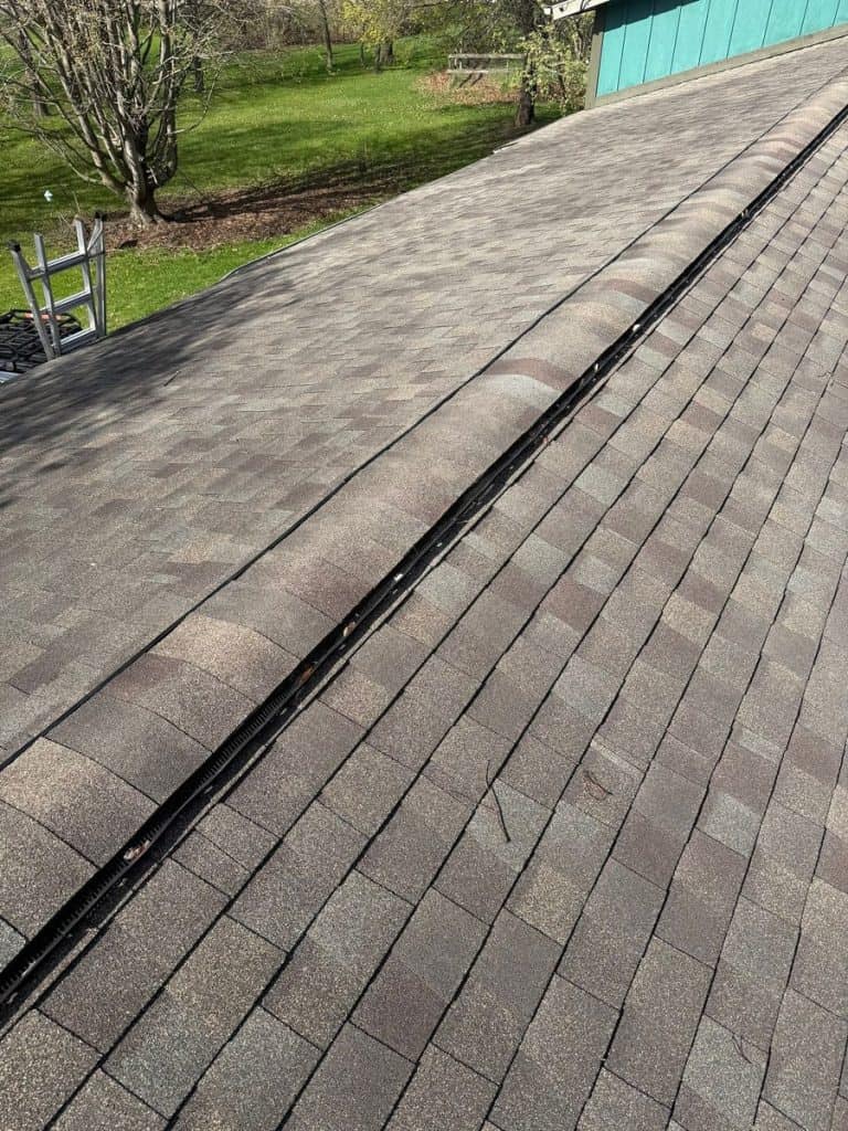 Completed architectural shingle roof with ridge vent by IHC