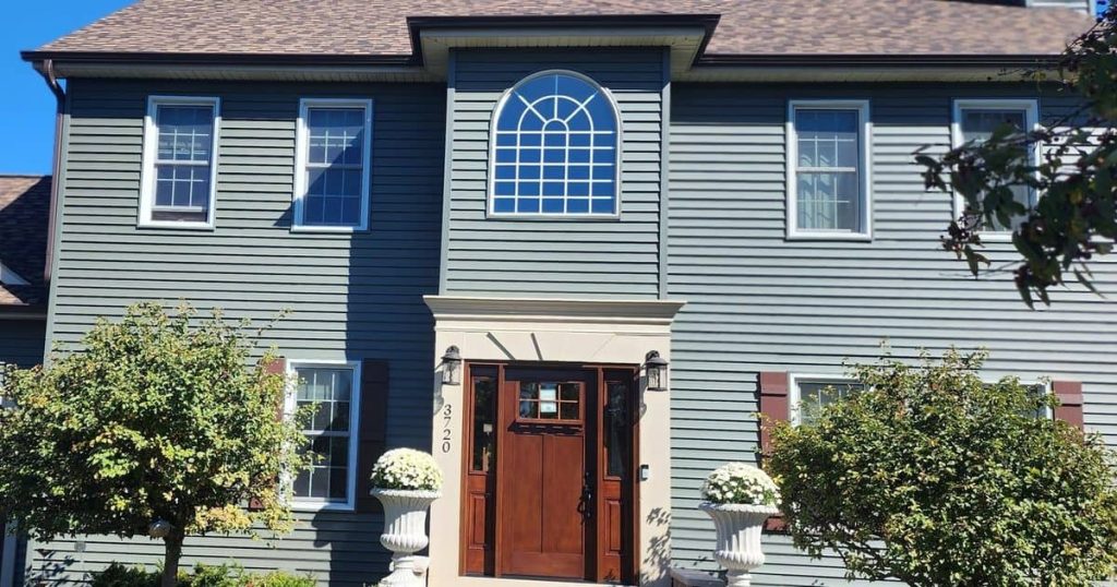 Two-story home with new blue siding and white trim in Crystal Lake IL