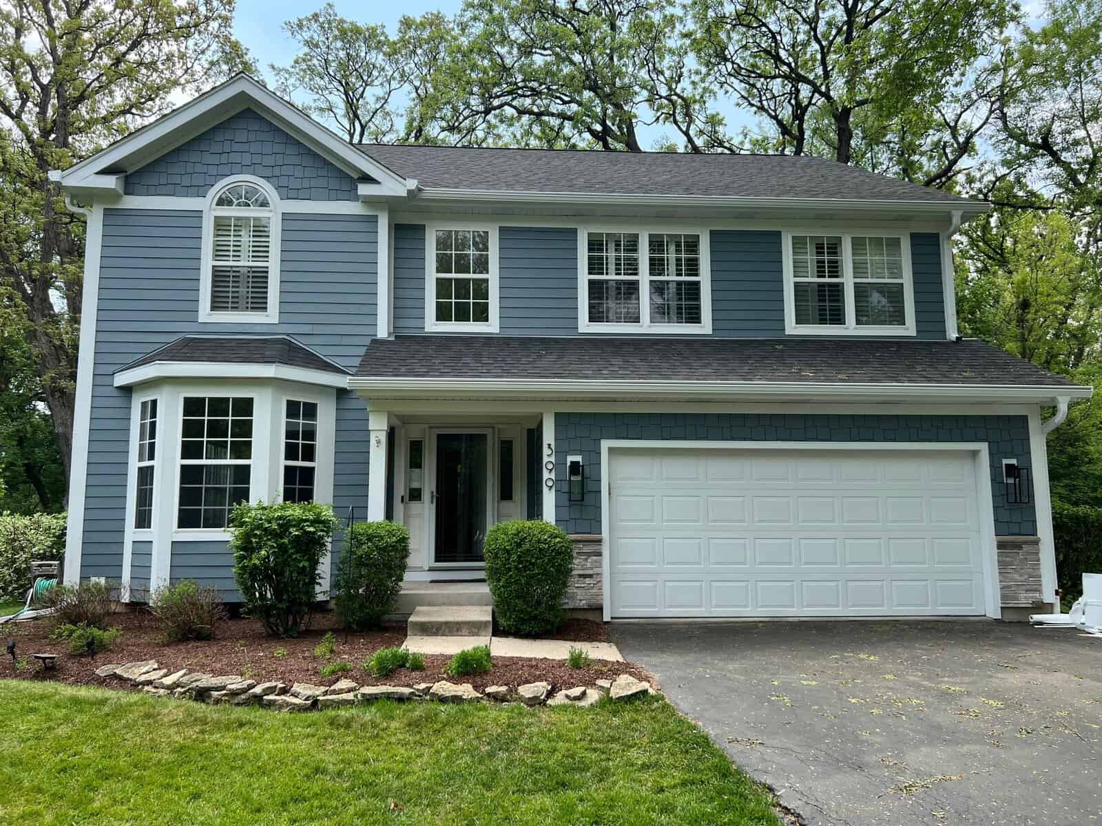 McHenry County home after — James Hardie siding, Versetta Stone, GutterShutter, asphalt roof