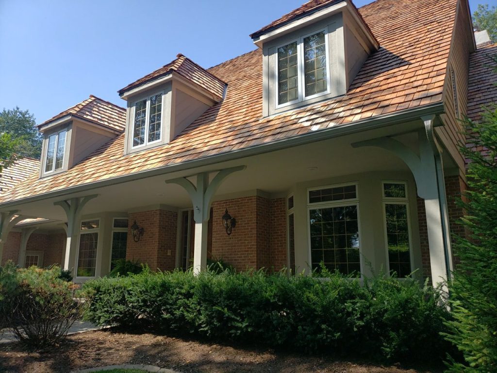 McHenry County residential GutterShutter install showing curved hood profile and heavy-gauge aluminum gutter channel