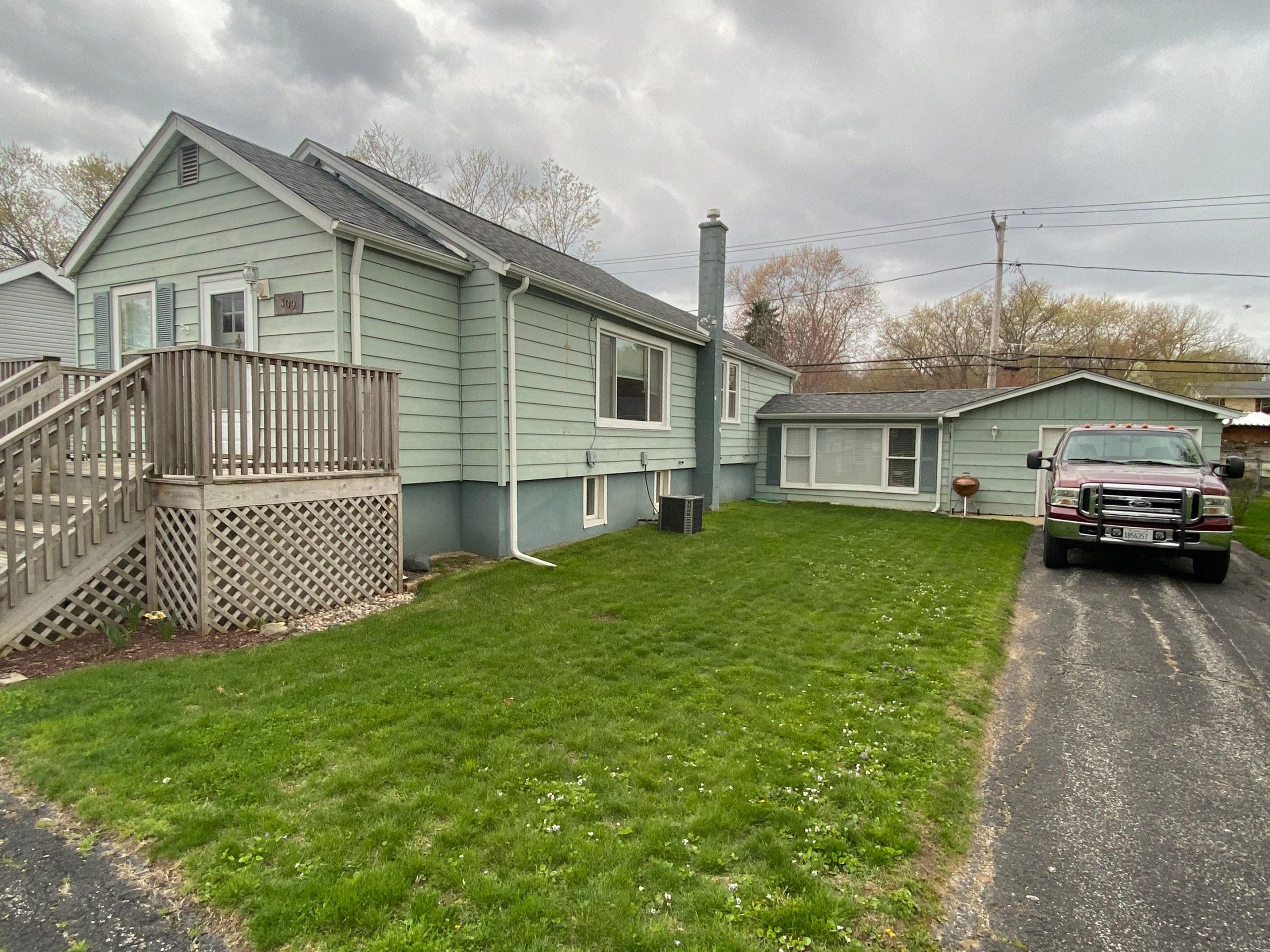 Lily Lake Road McHenry IL before — faded sage green vinyl siding with mint shutters