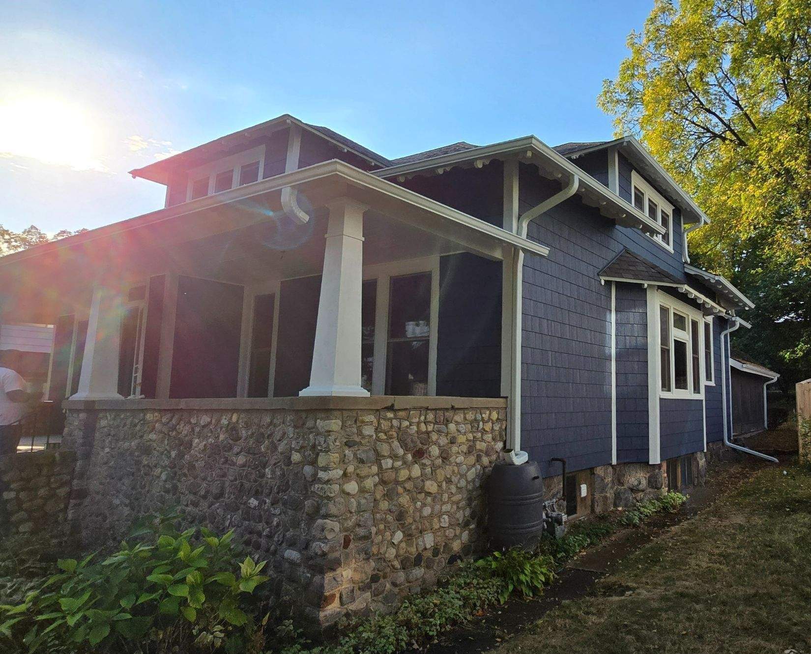 Lincoln Avenue Woodstock IL after — navy LP SmartSide shake siding, new white trim, new gutters, fascia, and soffit on craftsman bungalow