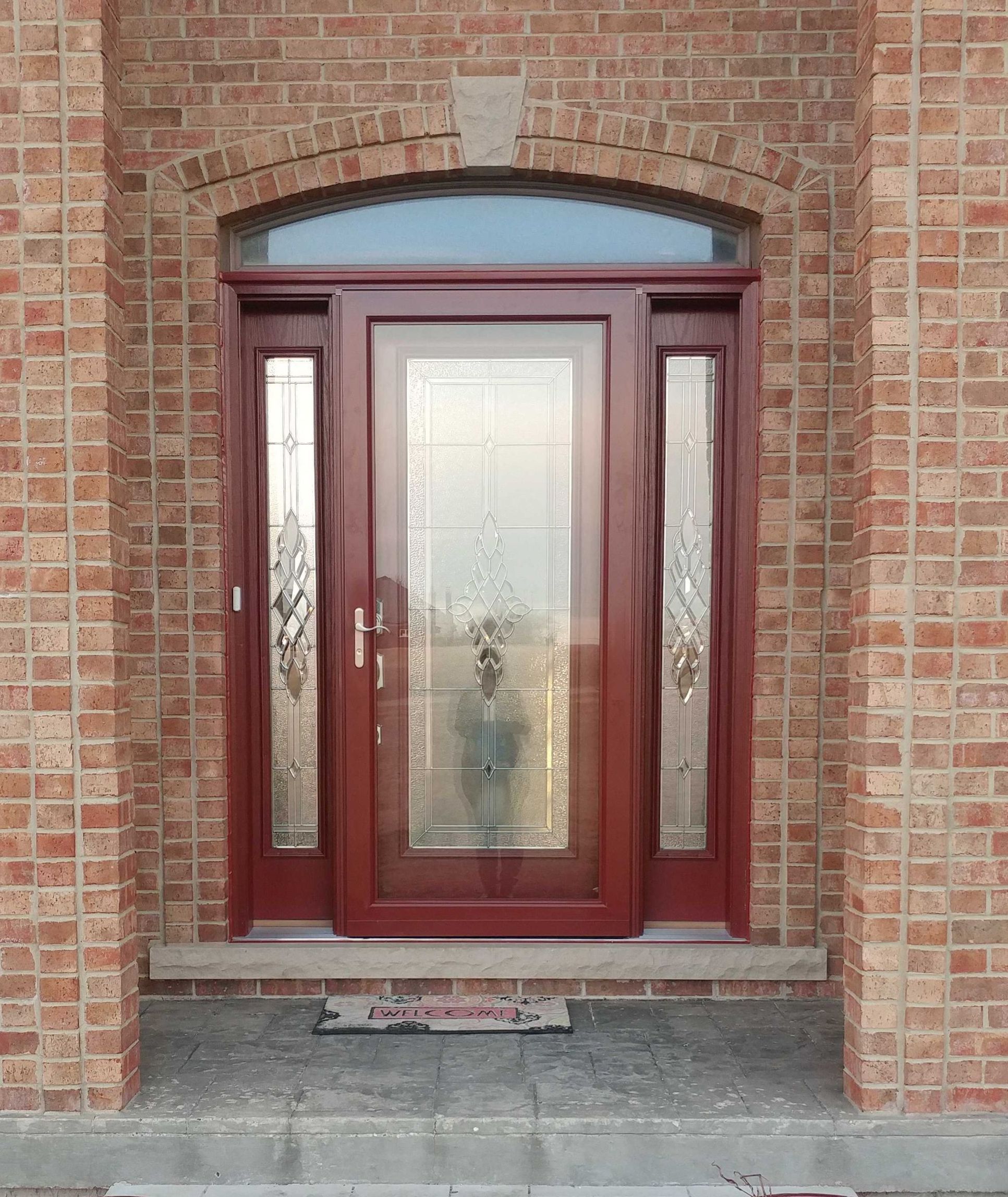 Margaret Court McHenry IL after — new ProVia door with decorative leaded glass and matching sidelights in red
