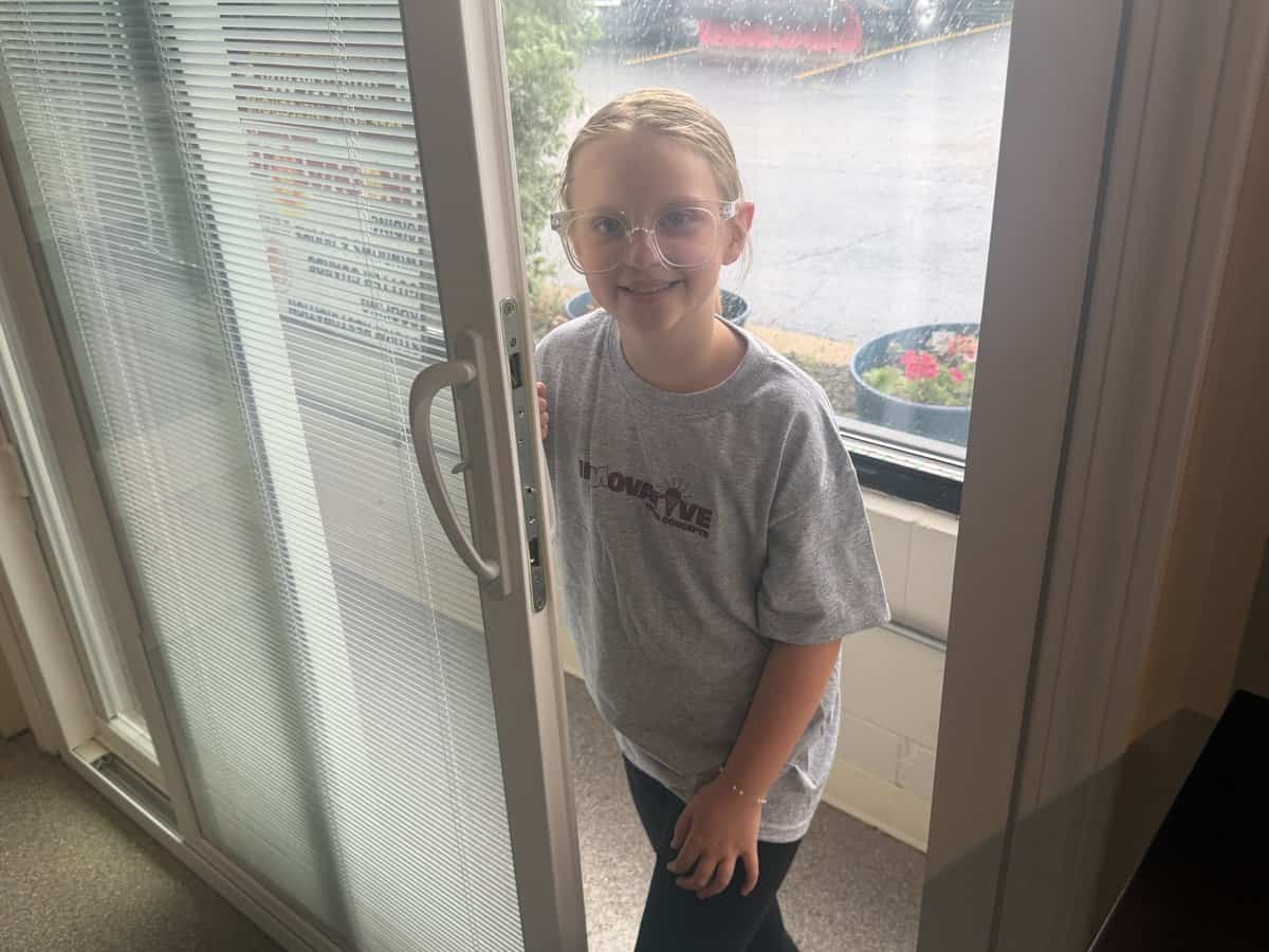 Olive operating a Midway vinyl patio door at the IHC Crystal Lake showroom