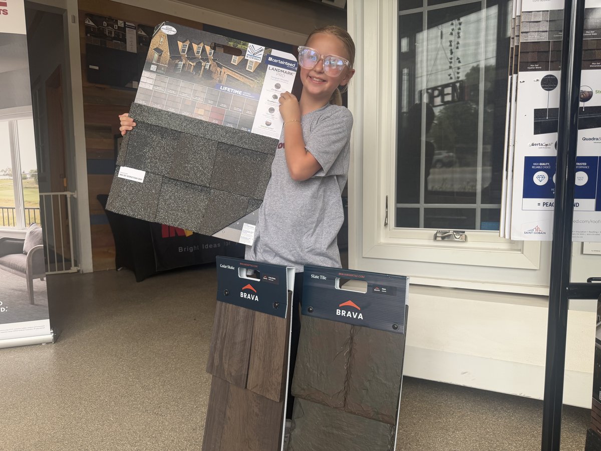 Olive holding CertainTeed roofing samples at the IHC Crystal Lake showroom
